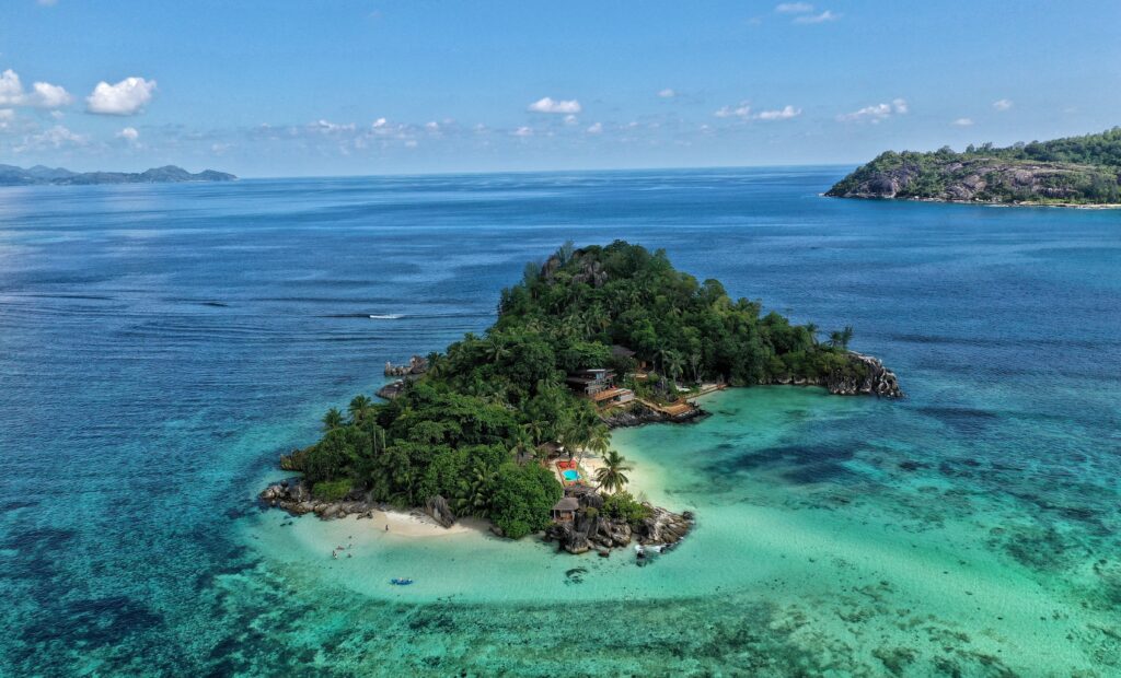 One of the islands that form the Seychelles, with stunning clear blue waters.